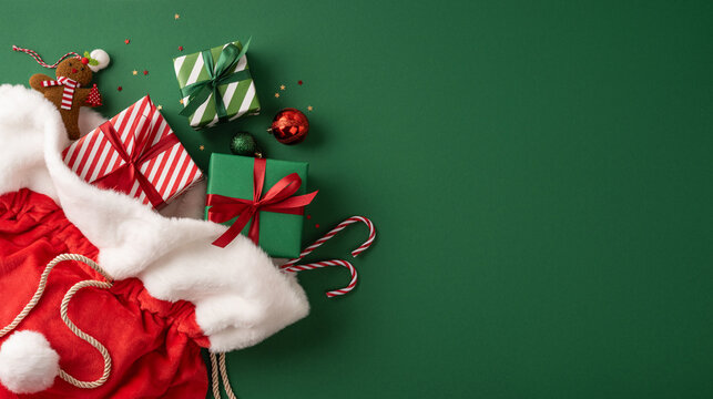 Santa Claus presents spilling from red sack with wrapped Christmas gifts, candy canes and festive bows for Merry Christmas and Happy New Year on banner background