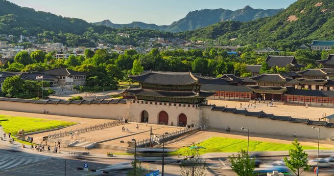 Gwanghwamun Gate and Gyeongbokgung Palace in Seoul, South Korea captured in a golden-hour timelapse with streaking traffic and mountain scenery behind traditional Korean architecture