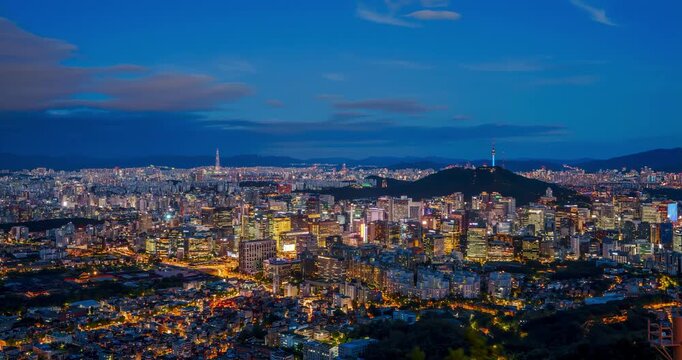 Aerial timelapse reveals Seoul's glowing night skyline over Jongno district with Namsan Tower on horizon
