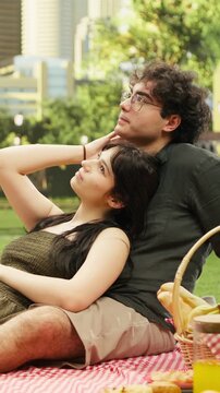 Vertical aspect: Young woman resting head with eyes closed against her boyfriend