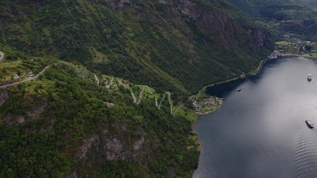 Aerial view of mountain road with hairpin turns descending to fjord  Norway