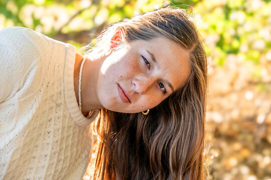 Woman with long hair outdoors in sunlight