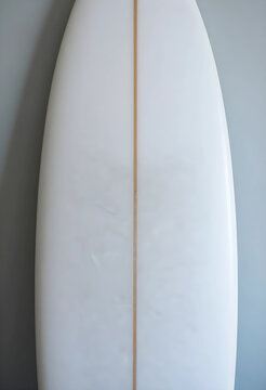 Surf culture and beach lifestyle, white surfboard with wax texture and wooden stringer against a light blue wall