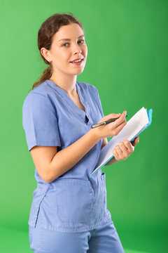Nurse in blue uniform takes notes on documents while interviewing a virtual patient