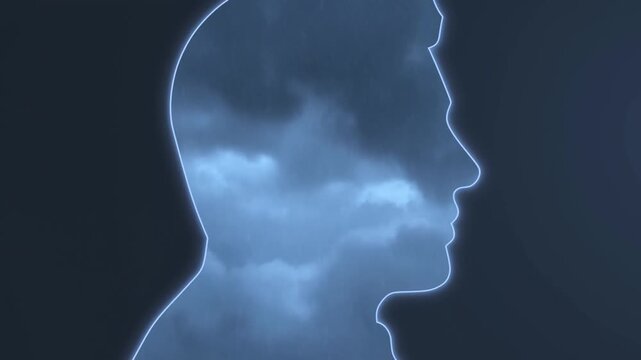 Glowing human head profile silhouette with cloudy blue texture on dark background
