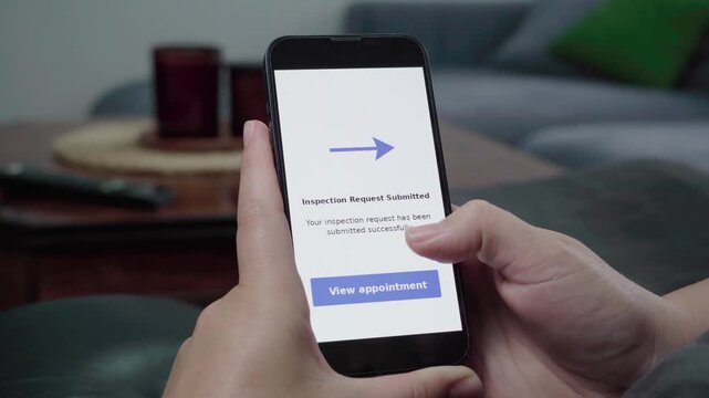 Hands hold a phone showing an Inspection Request Submitted confirmation with a blue View appointment call-to-action.