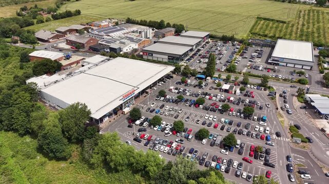 Aerial drone footage of Evesham in Worcestershire, England, showcasing the historic townscape, residential areas, River Avon, green spaces, and surrounding countryside from an elevated perspective.