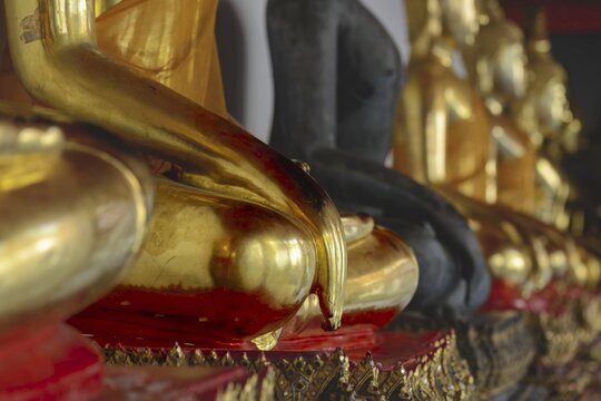 Gold-plated Buddha statues (Bhumispara-mudra: Gautama Buddha at the moment of enlightenment), Wat Pho, Bangkok, Thailand