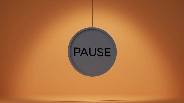 Hanging Pause Sign Suspended Against Warm Orange Background in Still Studio Scene