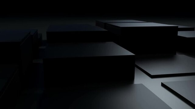 Dark rectangular panels arranged in rows across a reflective surface in a studio