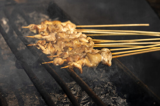 Satay, a famous Indonesian dish, with skewered meat grilled over hot charcoal