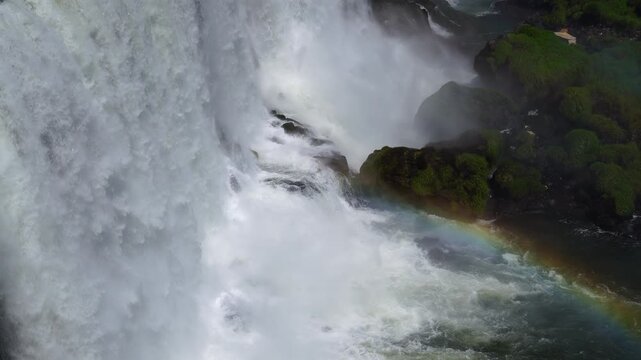 Aerial view of the powerful waterfalls with a rainbow in the mist