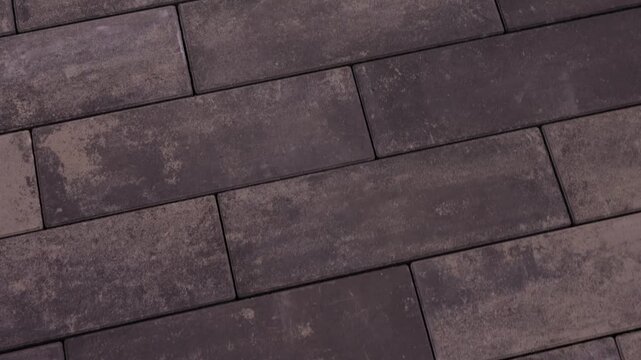 Dark rectangular paving stones arranged in modern walkway pattern
