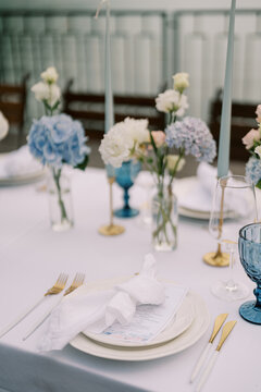Elegant wedding dinner table setting with flowers and candles