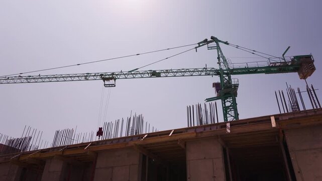 Tower crane above reinforced concrete building under construction