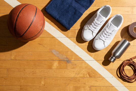 Warm basketball gear flat lay on a hardwood court