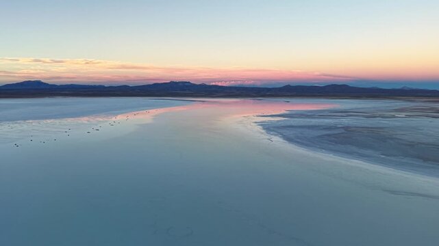 Salar de Uyuni salt flat at pastel sunset in Bolivia