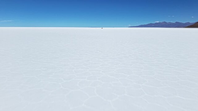 Salar de Uyuni salt flat beneath clear blue sky