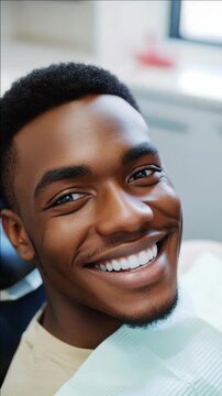 Smiling African American man with white teeth in a dental clinic