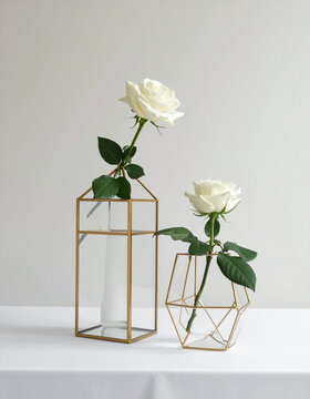 White roses in geometric vases