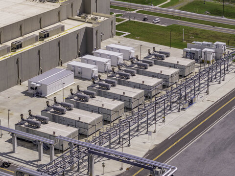 Aerial view of large diesel or natural gas engines and electrical generators at a data center, with industrial piping and concrete pads in Clarksville, Tennessee, United States.