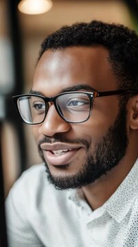 Smiling African American man with beard and glasses