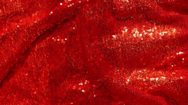  Sequin Fabric Waves as Holiday Background.red shimmer celebration background.Scales background. Background with shiny sequins.