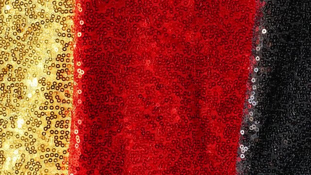 gold, red and black sequined fabric for German Unity Day ,presentations and event announcements. German patriotic design. 4k footage