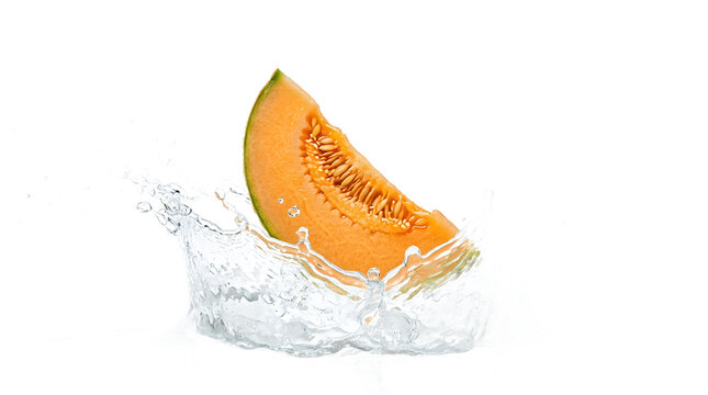 Fresh cantaloupe melon slice splashing into clear water, isolated on white background
