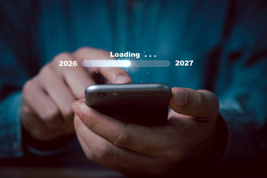 2026 to 2027 transition loading on smartphone symbolizing New Year countdown, digital progress, technology update, future planning and moving forward into a new year with innovation.