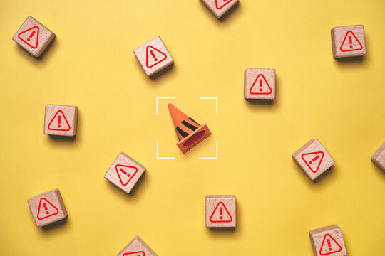 Risk management concept with traffic cone targeted among warning signs symbolizing hazard detection, safety focus, problem identification, crisis prevention and proactive business risk control.