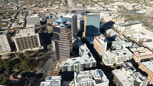 Tucson, United States - 17 December 2023: Aerial view of the downtown skyline featuring modern high-rise buildings, urban streets, and surrounding desert architecture under clear daylight.