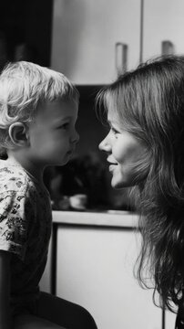 Close-up of a mother and son sharing an intimate moment in black and white