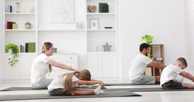 Happy family doing exercise together at home