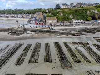 Aerial drone view of underwater oyster farms in Cancale, Brittany, exposed during low tide, raditional sustainable aquaculture and production of premium French oysters, France © barmalini