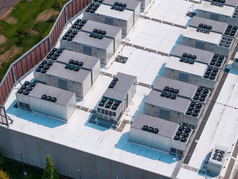 Aerial view of the Hillsboro data centers featuring rows of industrial HVAC cooling units on a flat white roof in Hillsboro, Oregon, United States.