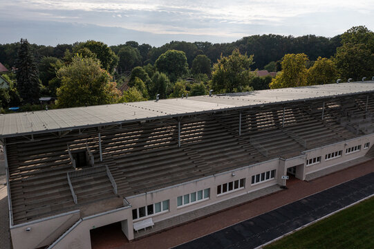 Aerial view of Regattatribune Berlin-Grunau with its historic grandstand seating, concrete architecture, and surrounding lush greenery in Berlin, Berlin, Germany.