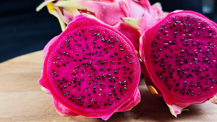 Fototapeta premium Fresh Dragon fruit on wooden with black background