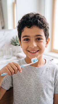 Cheerful Middle Eastern Boy Brushing Teeth High-Key Commercial Portrait