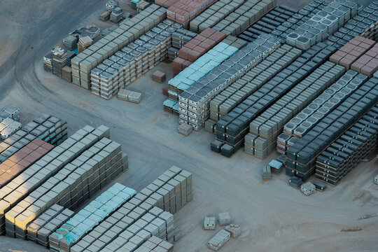 Aerial view of stacked concrete blocks and paving stones arranged in rows at a storage yard in Poland.
