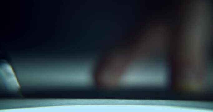 Extreme close-up of man's hand drawing a technical blueprint with a pencil and ruler, captured with shallow depth of field. Detailed drafting and design concept representing architecture, engineering.