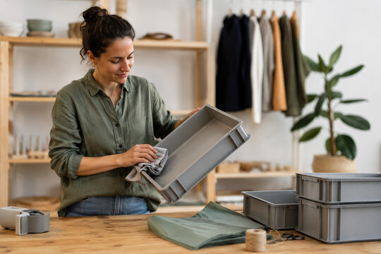 Small Business Worker Preparing Reusable Shipping Containers
