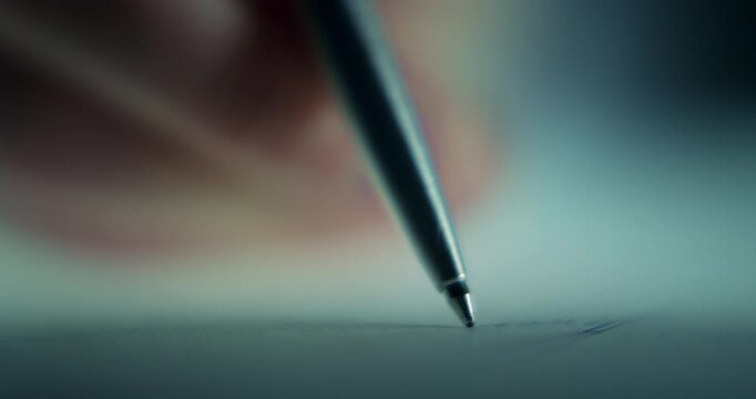 Extreme close-up footage of a man's hand signing an important document with a pen, captured with a shallow depth of field and cinematic focus. Conceptual footage representing contracts and agreements
