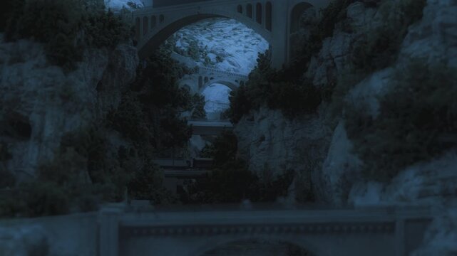 Train crossing Viaduct bridge, mountain cliffs, at night, the concept of interrail