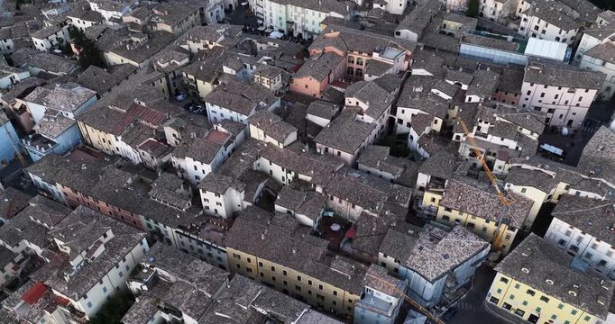Aerial view of historic rooftops and narrow streets of the old town in Spoleto, Umbria, Italy.