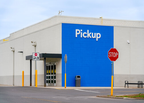 New Hartford, NY - Apr 21, 2026: Close-up view of the Walmart Pickup entrance at Consumer Square Plaza, an American retail superstore with over 10,500 locations worldwide