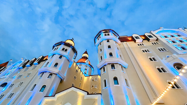 Bogatyr Hotel illuminated at dusk in Sochi