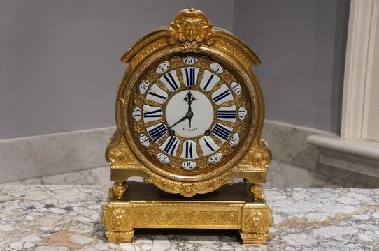 Philadelphia, Pennsylvania, U.S.A - July 10, 2026 - An antique Louis XVI style Paris mantle lock with gold frame Roman numerals and decorative motifs