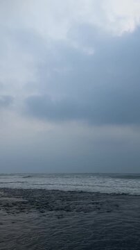 Dark storm clouds over rolling ocean waves