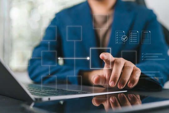 Businessman reviews a process flowchart to manage workflow automation, showing operational efficiency, structured procedures, and optimized business performance through digital systems.